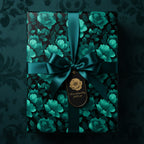 Elegant gift wrapped in dark floral wrapping paper with emerald ribbon and gift tag.