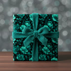 Teal floral wrapping paper on a square gift box, tied with a matching fluffy ribbon bow.