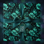 Elegant floral wrapping paper with emerald ribbon and star tag, ideal for birthday gifts or special occasions.