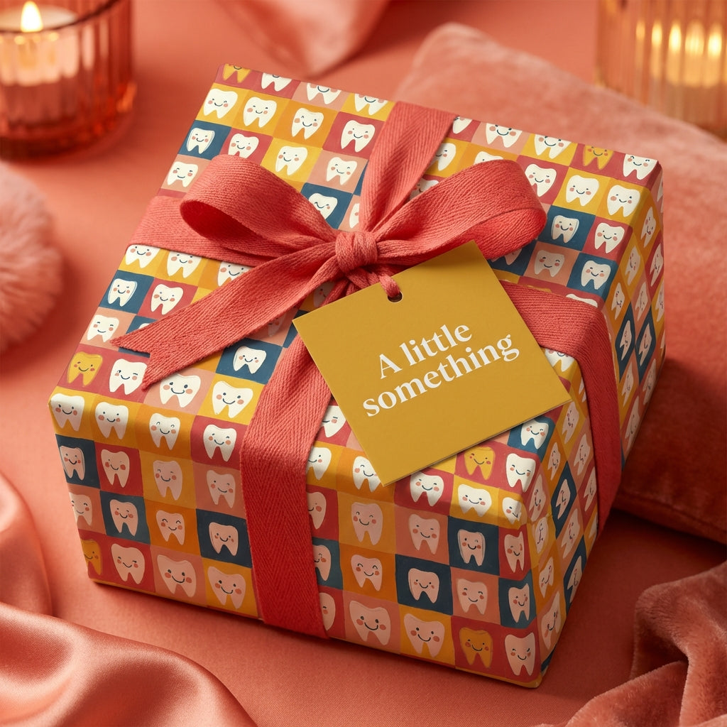 Fun, quirky dental themed gift wrapped with coral ribbon and "A little something" tag for dentist gift.