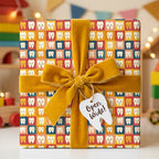 Kids’ novelty gift wrap featuring tooth pattern, tied with gold velvet ribbon in a child’s playroom setting.
