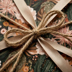 Boho floral wrapping paper with a rustic twine bow and beige ribbon by Wrapped Studios.