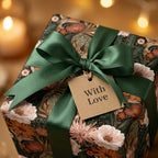 Luxury floral wrapping paper with green satin bow and "With Love" gift tag by Wrapped Studios.