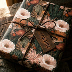 Rustic desert floral gift wrap with a leather bow and 'For Him' tag by Wrapped Studios.