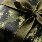 Luxury green abstract wrapping paper with a textured olive ribbon by Wrapped Studios.