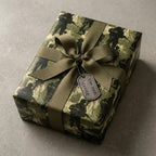 Military camouflage wrapping paper with olive ribbon and "For Your Service" dog tag by Wrapped Studios.