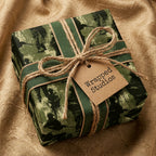 Military camo gift wrap by Wrapped Studios on a gift box tied with rustic twine and green ribbon.