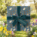 Elegant Easter gift wrap with floral, bunny, and cross pattern, tied with a velvet teal ribbon.