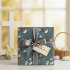 Elegant Easter gift with cross, bunny, and egg wrapping paper, tied with a silver ribbon.