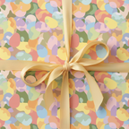 Pastel Easter egg wrapping paper with a gold satin ribbon.