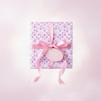 Gift wrapped in pink polka dot wrapping paper with pink satin ribbon and "Wrapped with Love" tag.