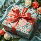 Luxury floral wrapping paper with pumpkins, coral satin bow, and 'With Love' tag by Wrapped Studios.