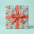 Vintage pumpkin wrapping paper with autumn floral pattern and coral bow by Wrapped Studios.