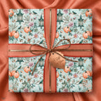 Vintage fall pumpkin wrapping paper with lanterns and birds, tied with terracotta ribbon by Wrapped Studios.
