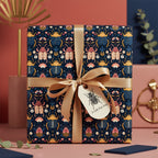 Elegant gift box wrapped in modern insect floral wrapping paper with gold ribbon.