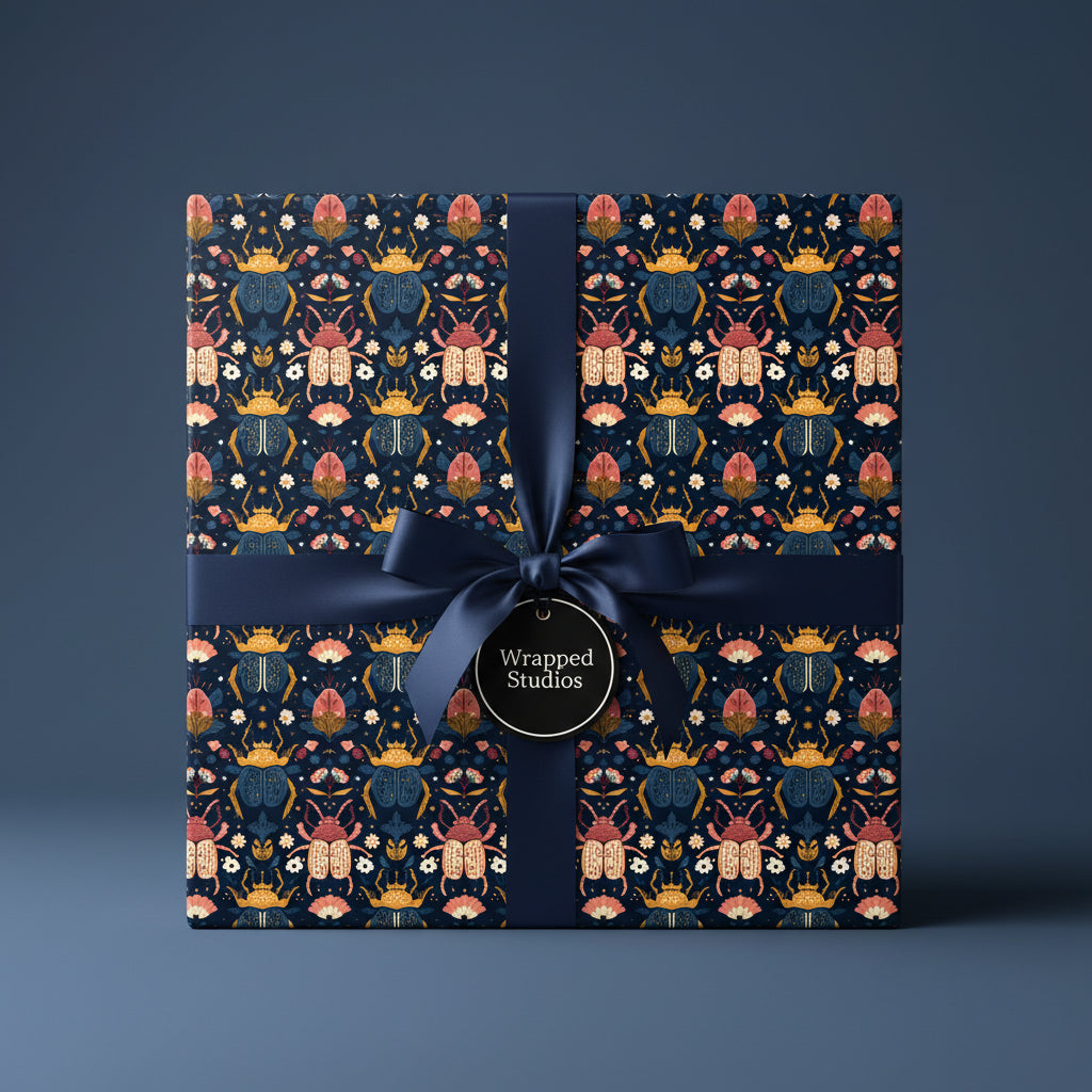 Luxury gift wrap featuring a beetle and floral design with a navy satin ribbon.