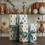 Gifts wrapped in beige wrapping paper with colorful beetle pattern tied with teal ribbon.