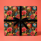 Gift box wrapped in colorful floral wrapping paper with a black velvet ribbon.