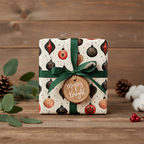 Merry & Bright Christmas gift wrapped in vintage ornament paper with a green ribbon, pinecones, and eucalyptus on wood.