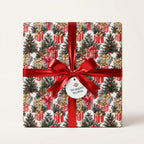 Christmas wrapping paper with festive tree print, tied in a red satin bow by Wrapped Studios.