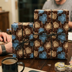 Brown floral wrapping paper with blue and gold flowers tied with black string.