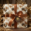 Luxury botanical wrapping paper with gold ginkgo leaf pattern and brown satin bow by Wrapped Studios.