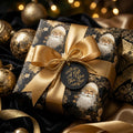 Luxury black and gold vintage Santa Christmas wrapping paper with a gold bow by Wrapped Studios.