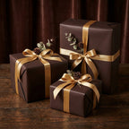 Elegant chocolate brown gift wrapping paper with gold satin ribbon & pinecone accents.