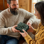 Couple exchanging a gift in dark green rustic Christmas wrapping paper by Wrapped Studios.