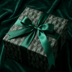 Luxury Christmas gift wrap with an emerald forest tree pattern and satin bow by Wrapped Studios.