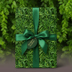 Gift wrapped in novelty grass-patterned wrapping paper with a green satin bow.
