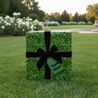 Square gift wrapped in grass-patterned paper with black velvet ribbon, perfect for "Yard Man!" gifts.