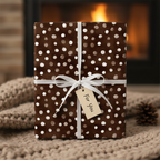 Elegant brown polka dot wrapping paper with a white ribbon and "For You" gift tag, perfect for luxury Christmas or birthday gifts by a fireplace.