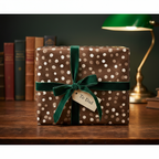 Elegant brown polka dot wrapping paper with a green velvet ribbon and "To Dad" tag, perfect for a luxury birthday gift.