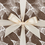 Brown leaf pattern gift box with elegant ivory ribbon, perfect luxury gift wrap for birthdays or special occasions.