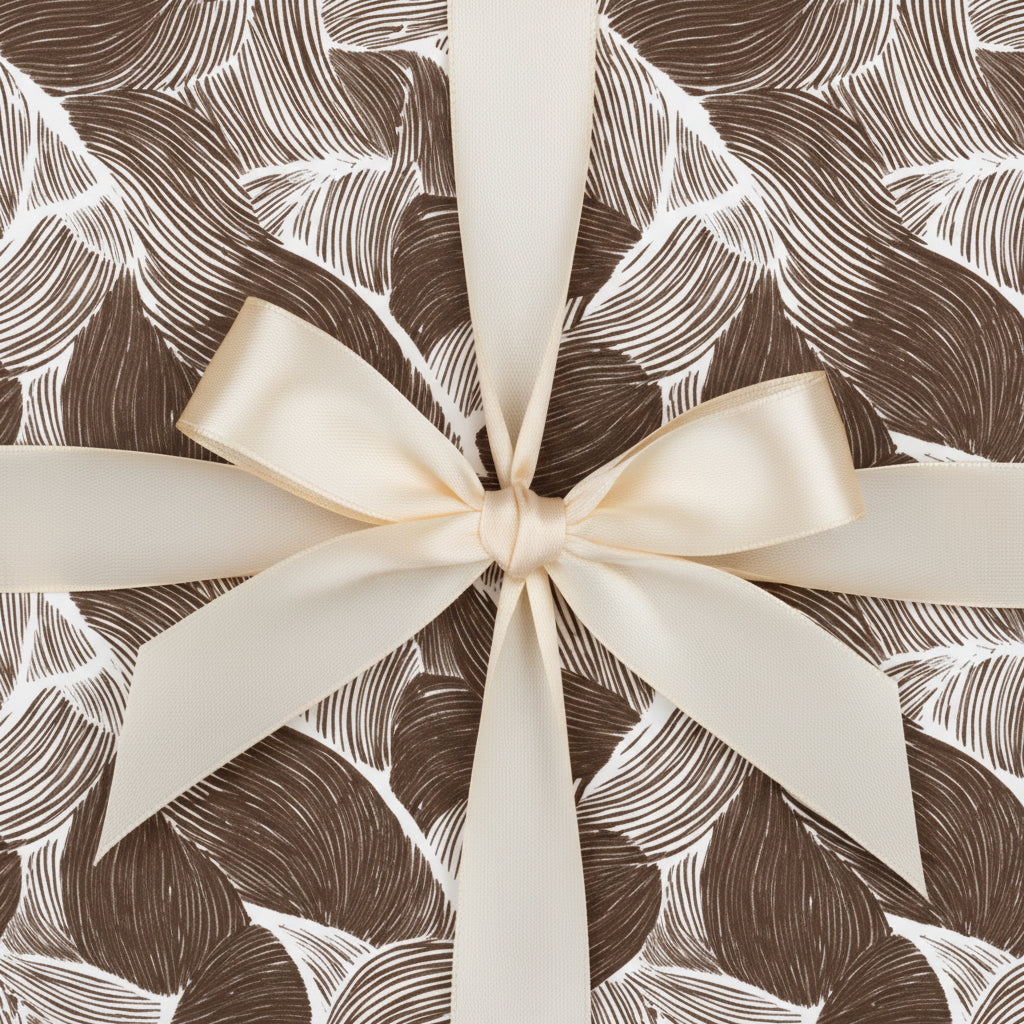 Brown leaf pattern gift box with elegant ivory ribbon, perfect luxury gift wrap for birthdays or special occasions.
