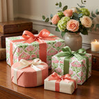 Elegant pink and green floral wrapping paper with luxury satin ribbons by Wrapped Studios.