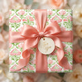 Elegant pink and green floral wrapping paper with a satin bow and 'For You' tag by Wrapped Studios.