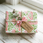 Elegant watercolor floral wrapping paper with a pink bow on a rustic gift box by Wrapped Studios.