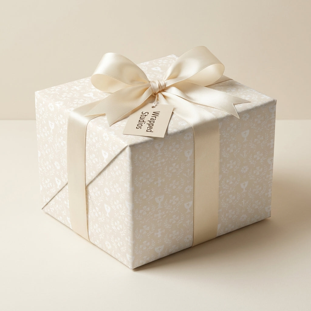 Elegant cream baptism wrapping paper with crosses and satin bow on a gift box by Wrapped Studios.