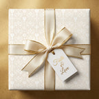Elegant baptism wrapping paper with crosses, cream satin bow, and gold faith tag by Wrapped Studios.