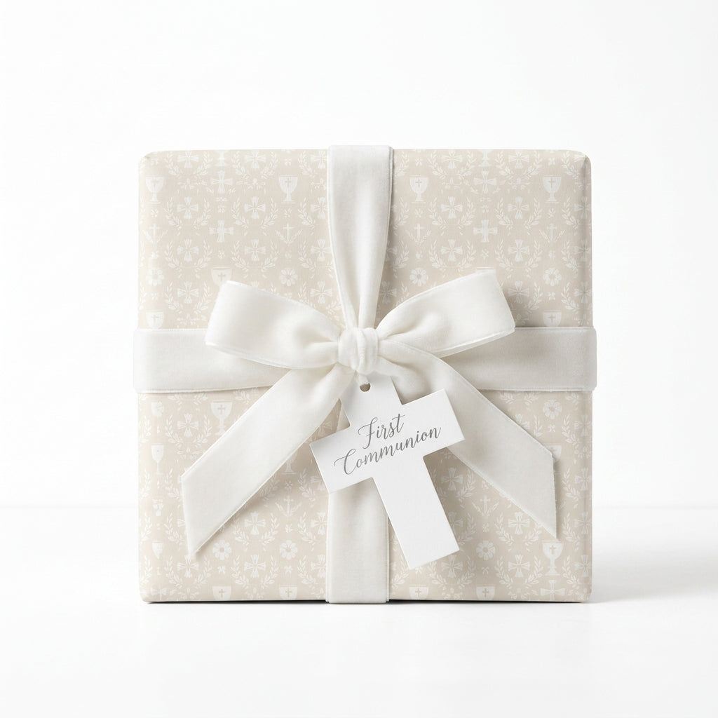 Elegant beige First Communion wrapping paper with a white velvet bow and cross tag by Wrapped Studios.