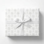 First Communion wrapping paper with elegant chalice pattern and white ribbon bow by Wrapped Studios.