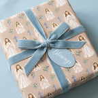 First Communion and baptism gift wrap with praying girl illustrations and blue velvet bow, Wrapped Studios.