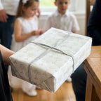 First Communion wrapping paper with silver chalices on a gift box, by Wrapped Studios.