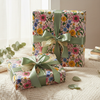 Gifts wrapped in pink floral wrapping paper with olive green ribbon bows, perfect for birthday or Mother's Day.