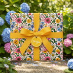 Square gift wrapped in pink floral wrapping paper with a yellow ribbon and "For You" tag.