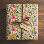 Floral wrapping paper on a gift box with a brown ribbon and "To My Friend" tag, perfect for birthday gifts.