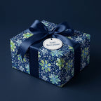 Navy floral wrapping paper with satin ribbon, perfect for a thoughtful "just because" gift.