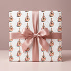 Boho acoustic guitar floral wrapping paper on a gift box with a pink bow, by Wrapped Studios.